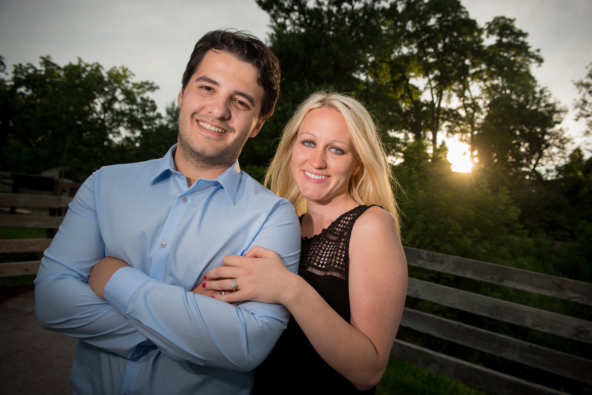 Linked armed engagement couple at sunset along the DuPage River