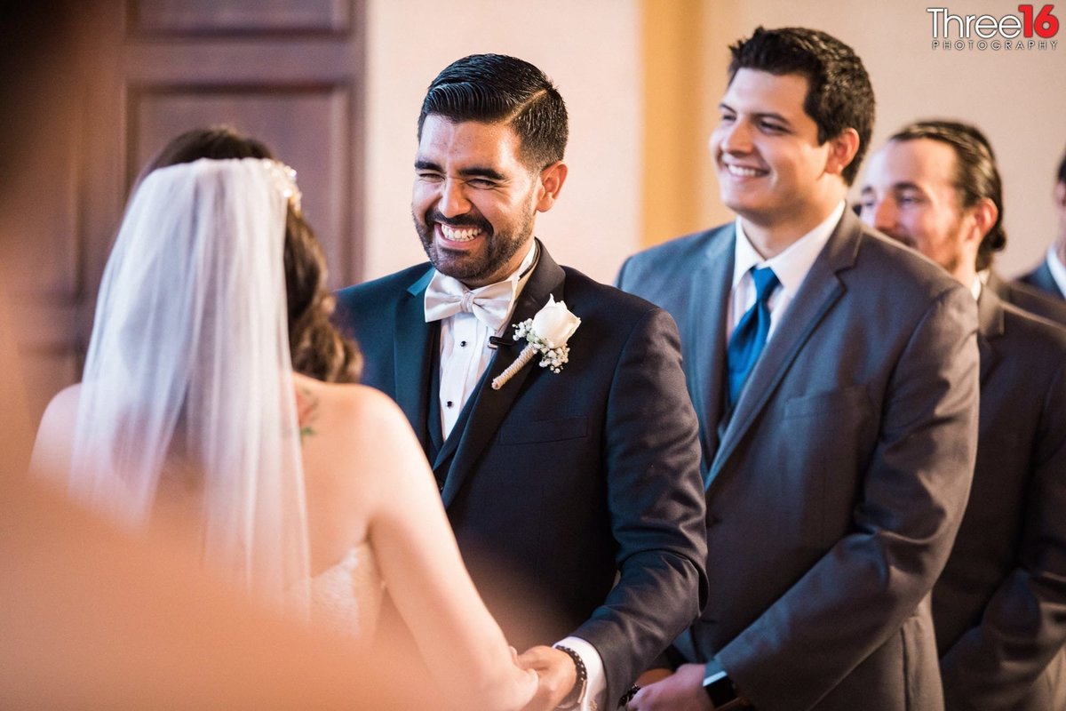 Groom starts to laugh during his wedding ceremony