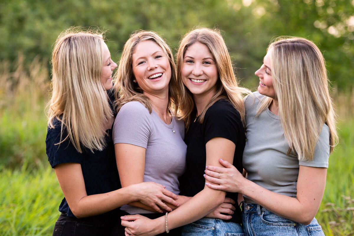 four sisters laughing during their family session taken by Ottawa Family Photographer JEMMAN Photography