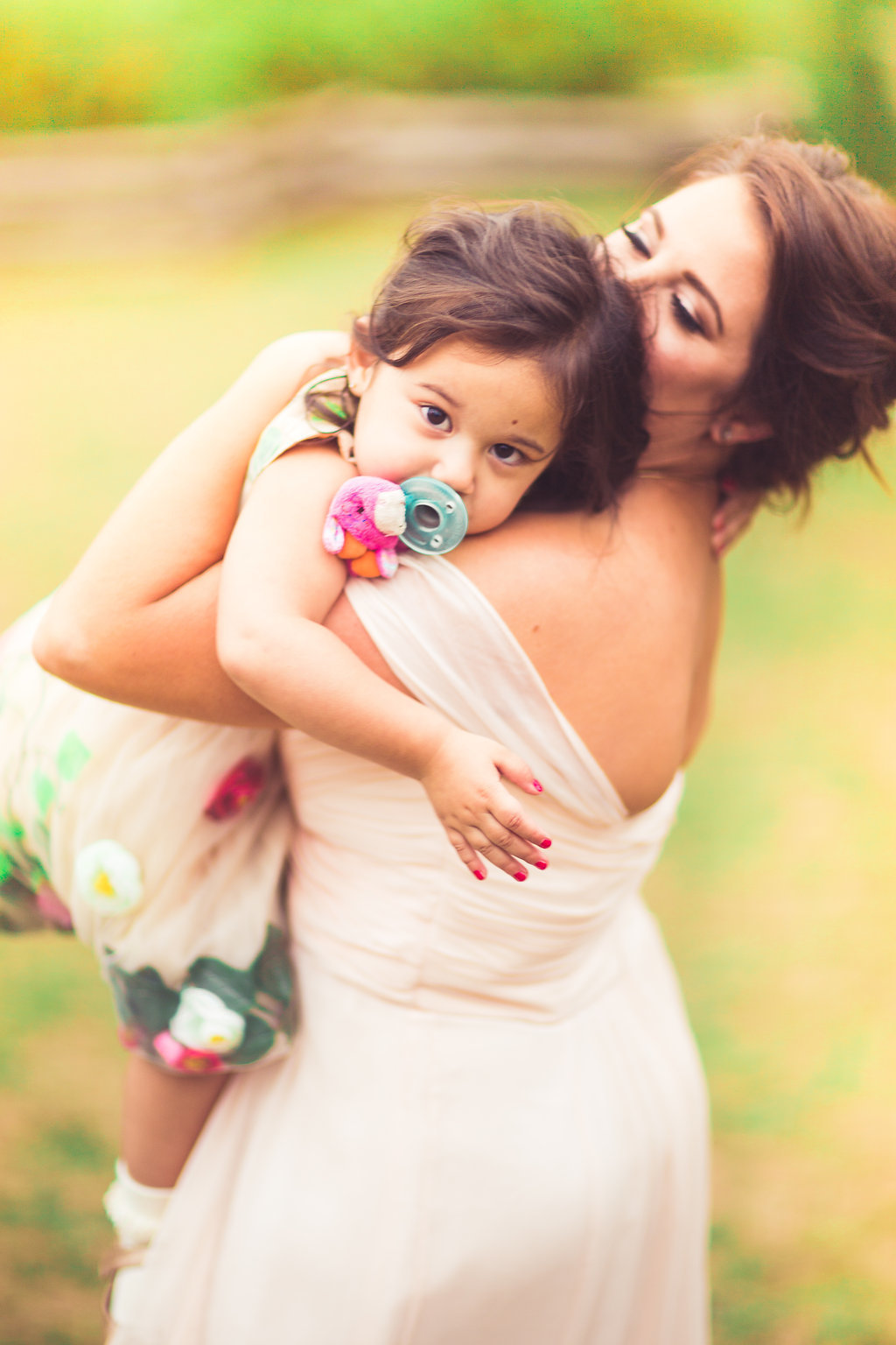 Wedding Photograph Of Woman in Dress Carrying a Toddler Los Angeles