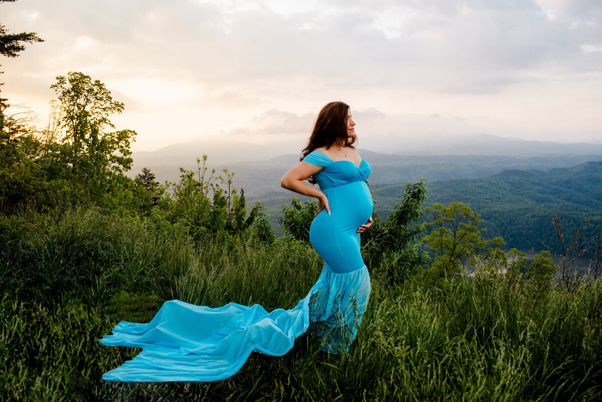 photo of pregnant woman in front of mountains