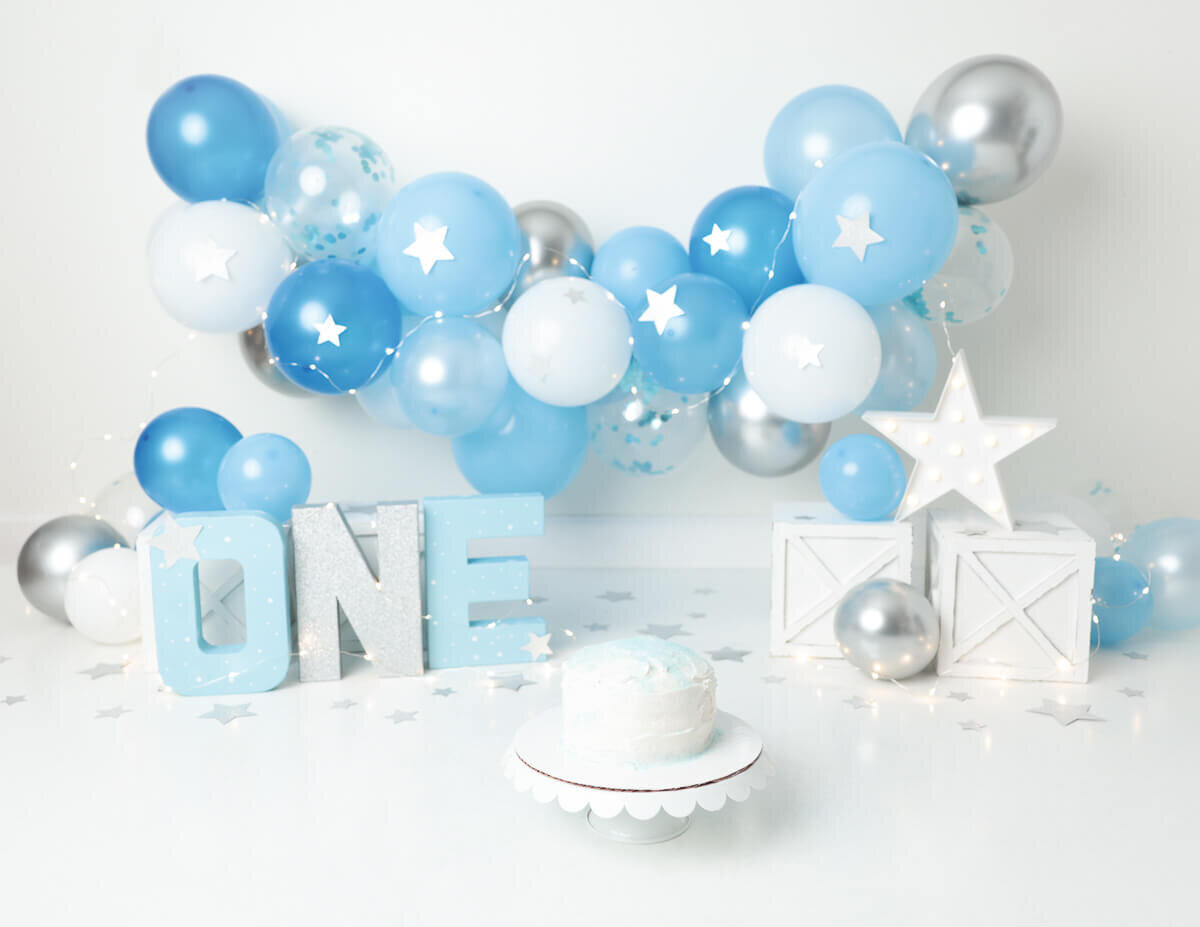 Festive scene of a custom cake smash with pastel balloons and cake in Rochester, NY, capturing the joy of childhood.