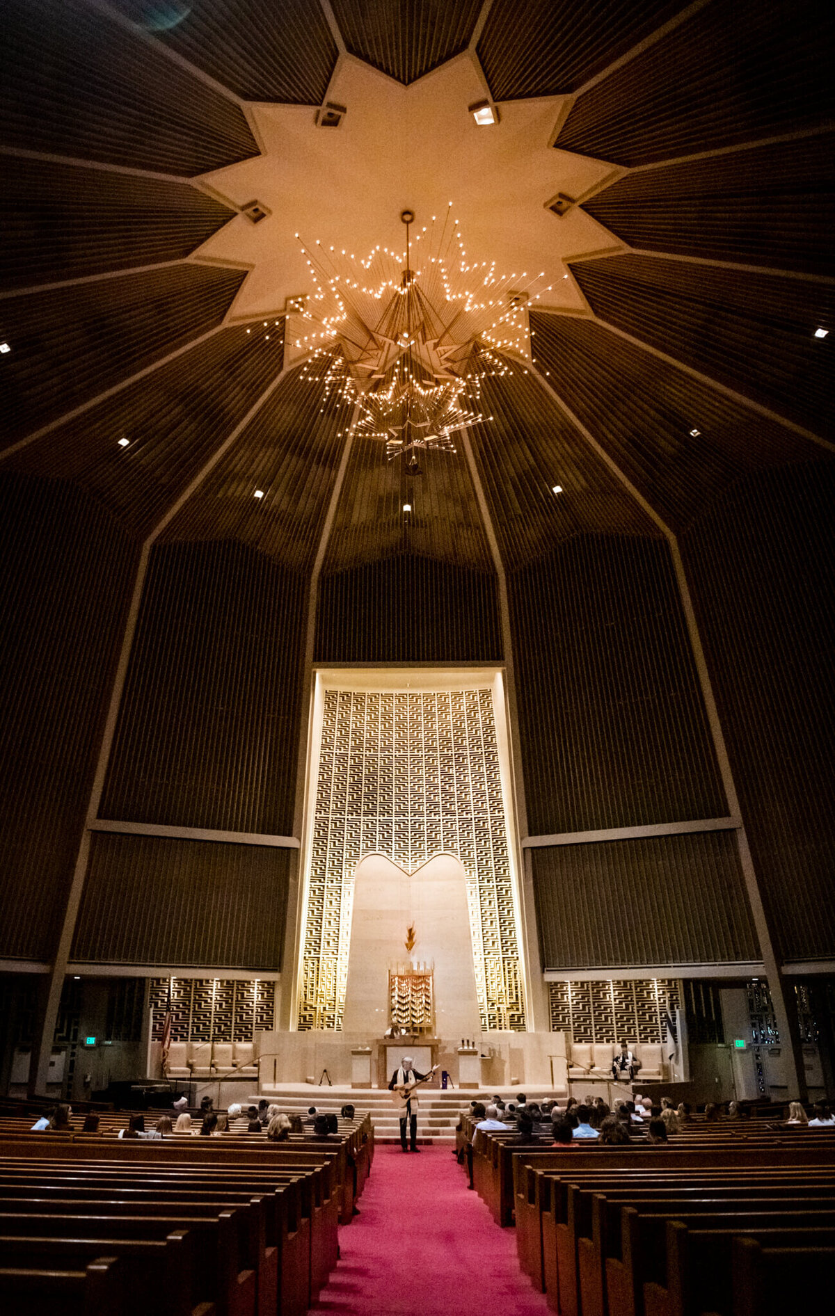 A Bellevue Bar and Bat Mitzvah Photography image of a dark temple during a service