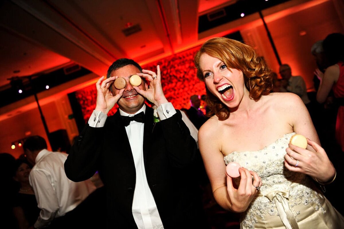 Bride and groom fun with the macarons