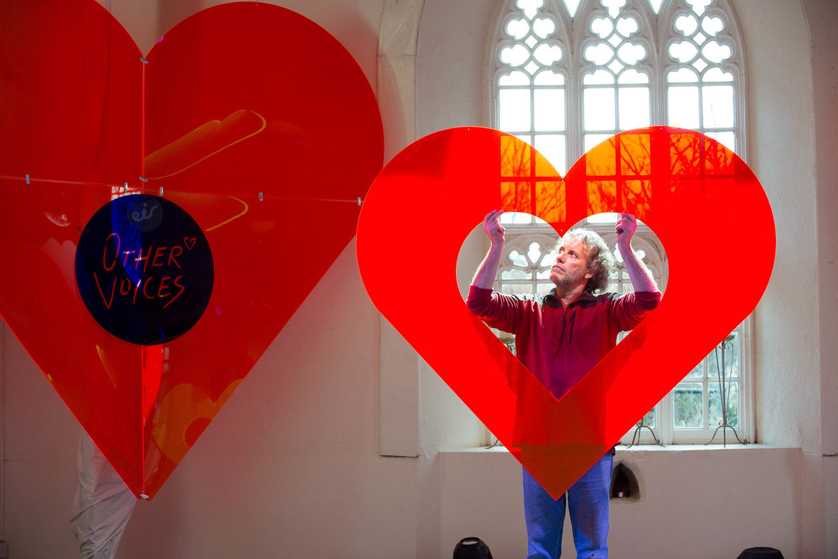 Set designer holding props for Other voices stage in St. James church, Dingle