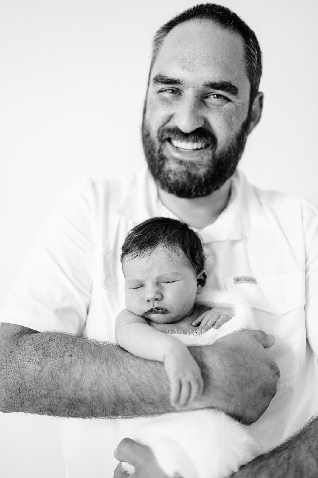 Father in black and white with baby.
