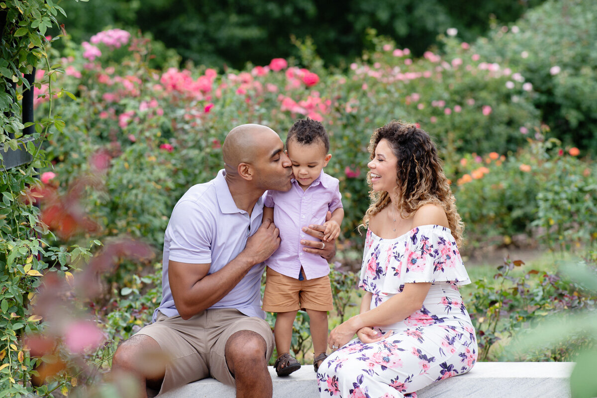 Family session located outside surrounded by flowers