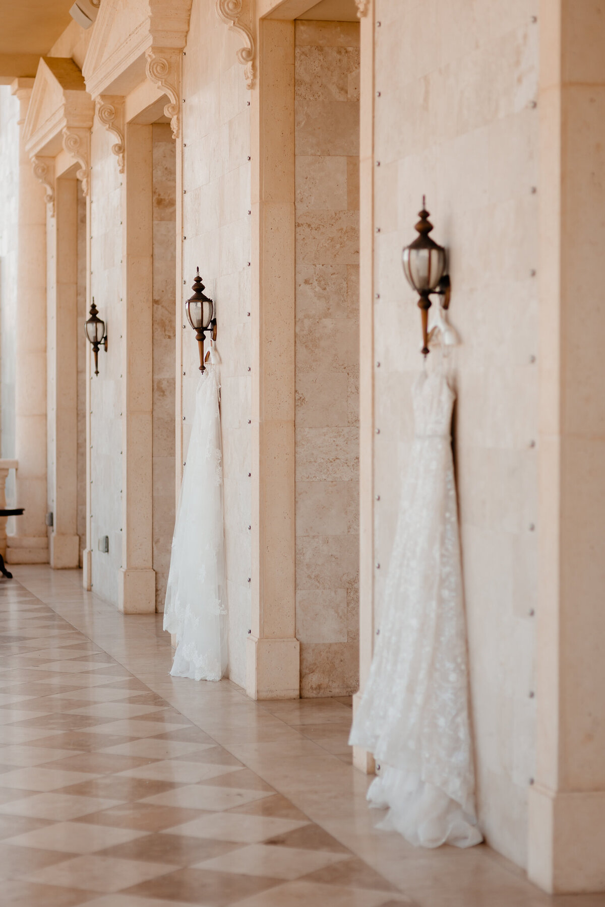 alt="two wedding dresses hanging at the regent weddeing"