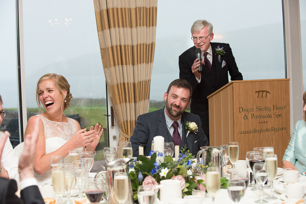 bride and groom laughing out loud during the father of the groom speech in the Dingle Skellig Hotel