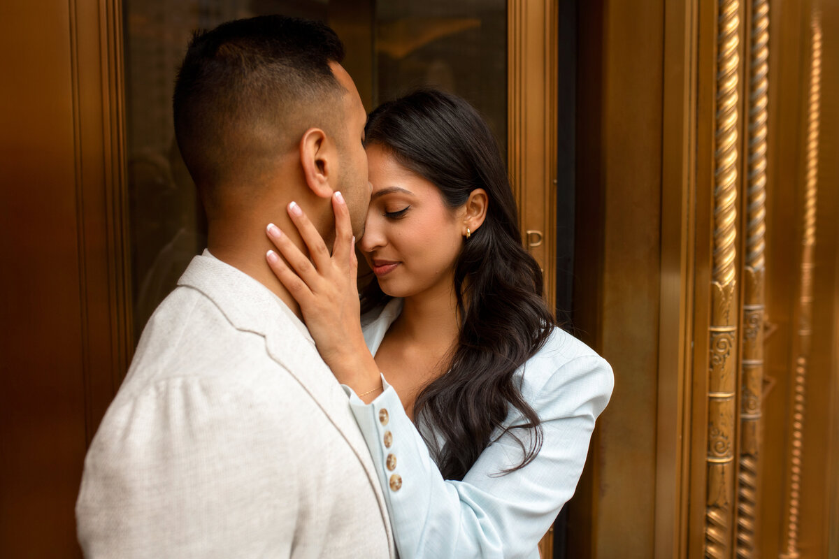 Beautiful young couple at the entrance of  Wrigley building door in Chicago