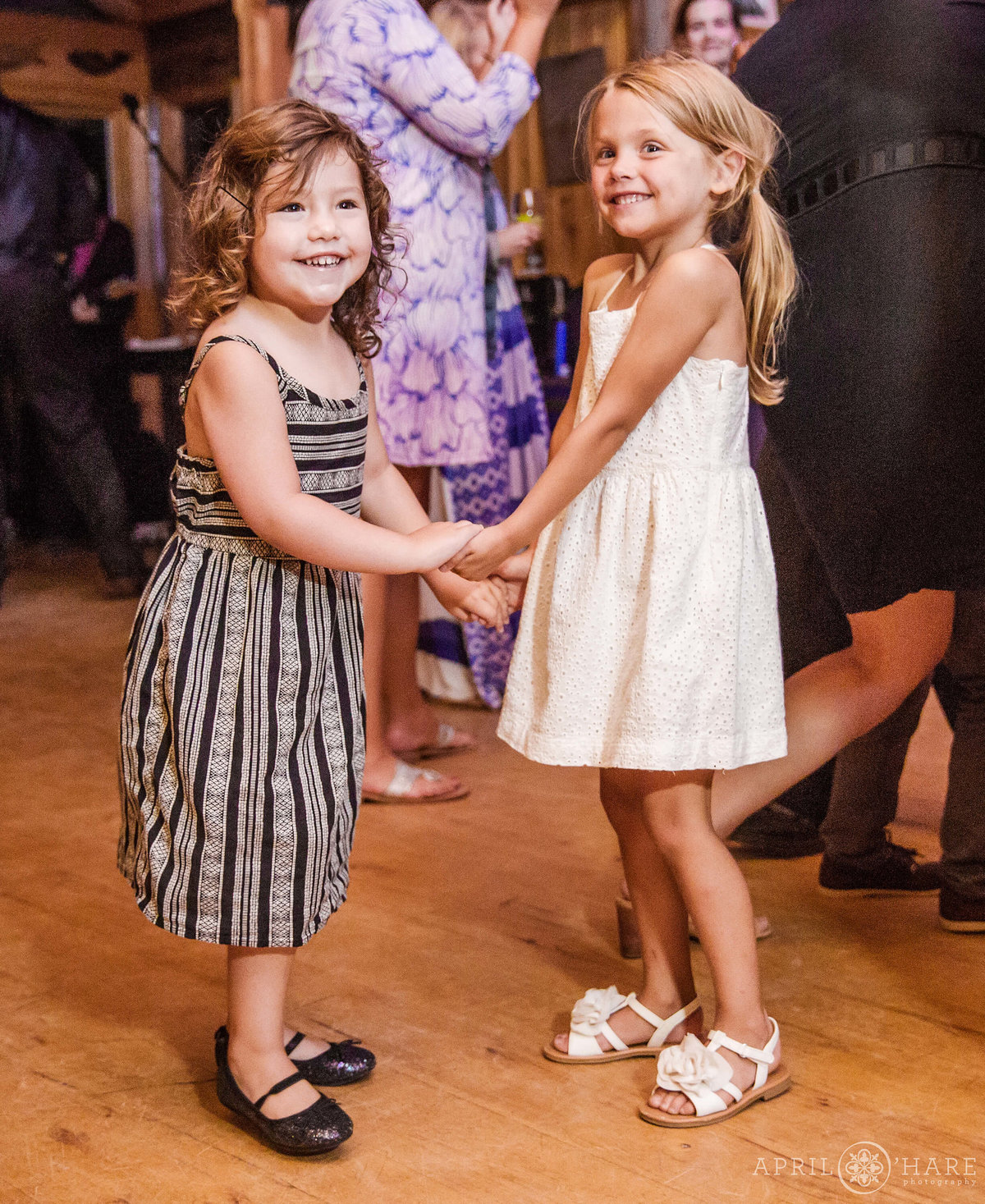 Sweet wedding photo of flower girls dancing at Reception in Colorado Mountains
