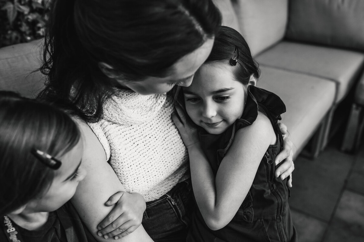 two girls snuggle mom at San Francisco in home family photography session