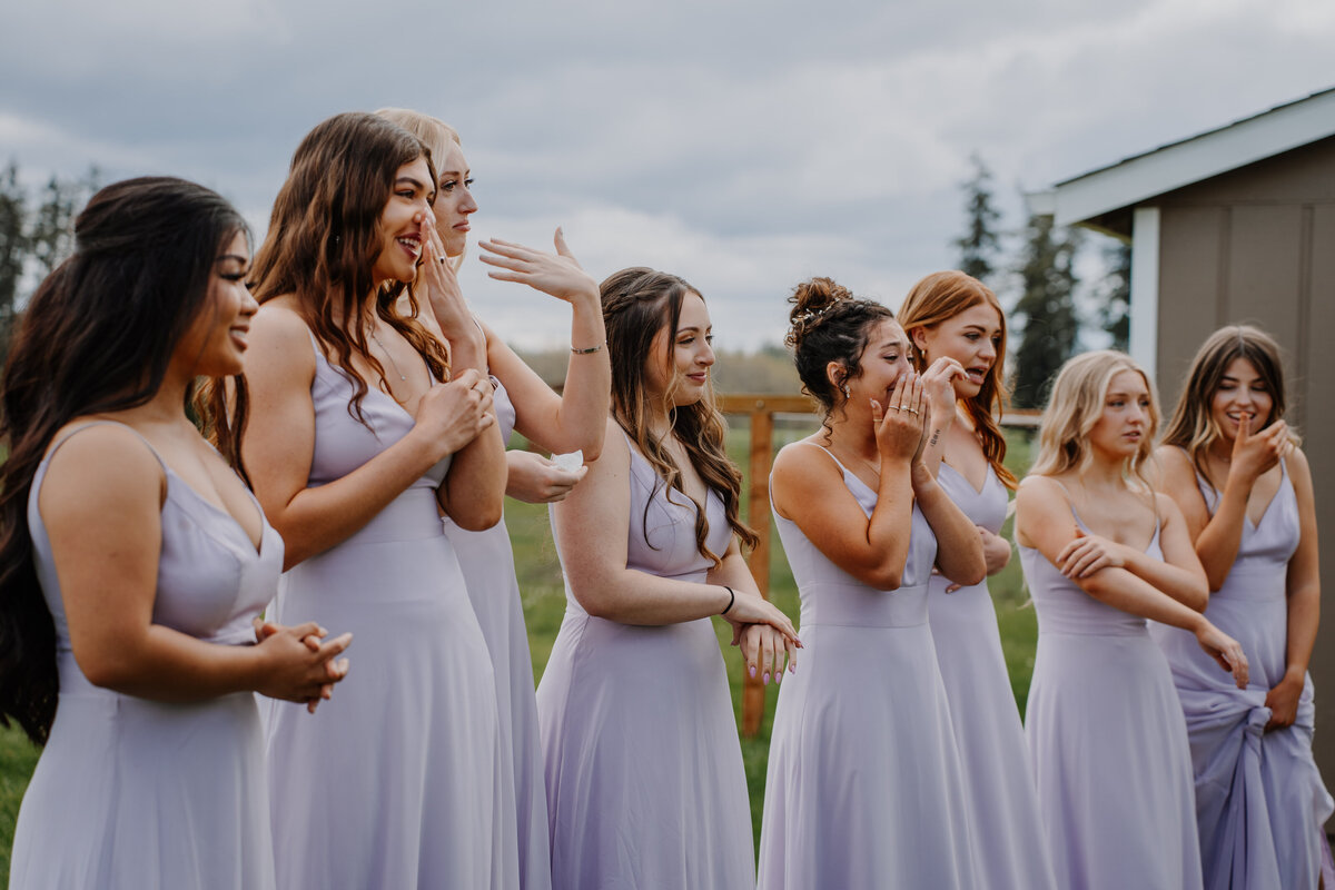 Bridesmaids in purple dresses smiling