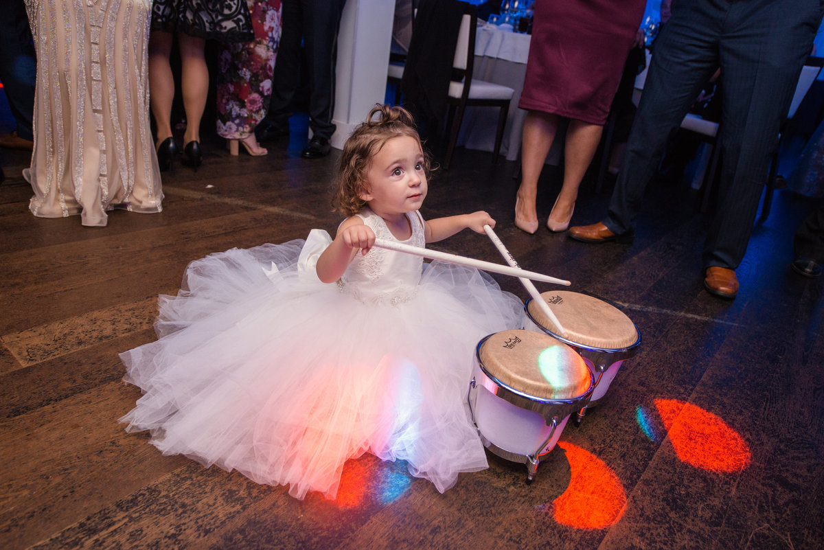 Flower girl playing the small drums