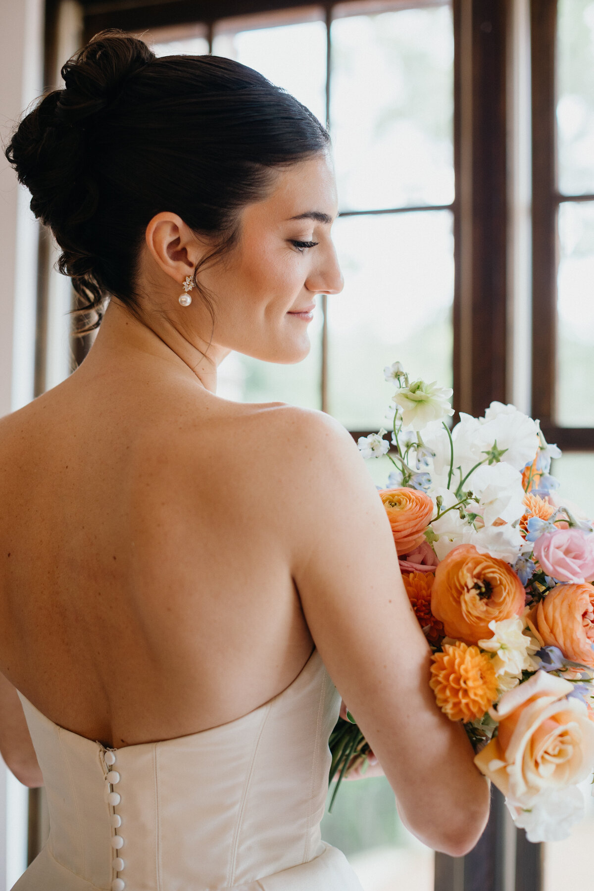 Bride holding floral bouquet for a side profile portrait