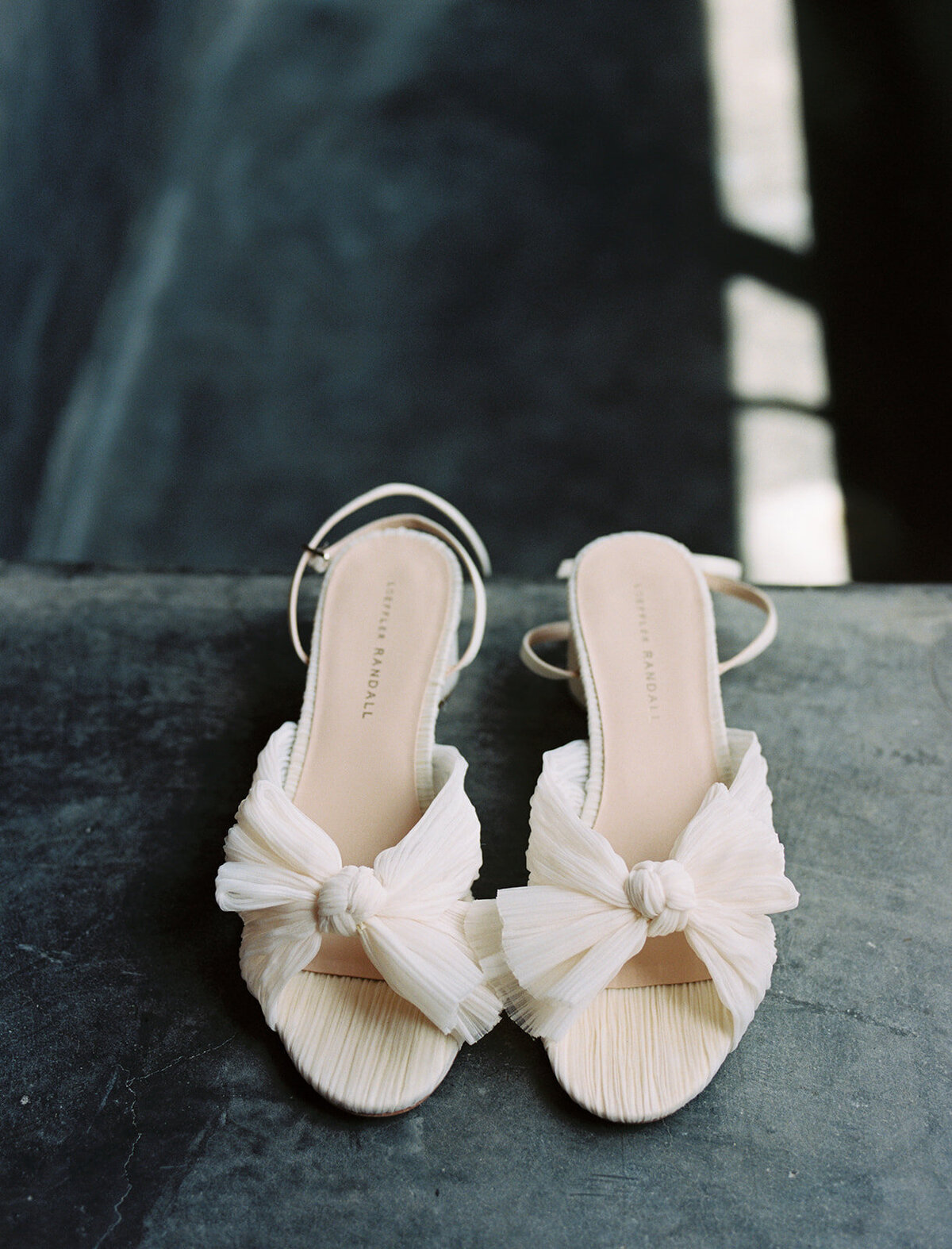 white bridal shoes with bows