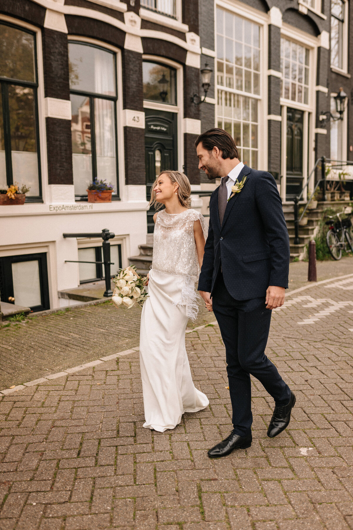 Brautpaar läuft auf Straße in Amsterdam