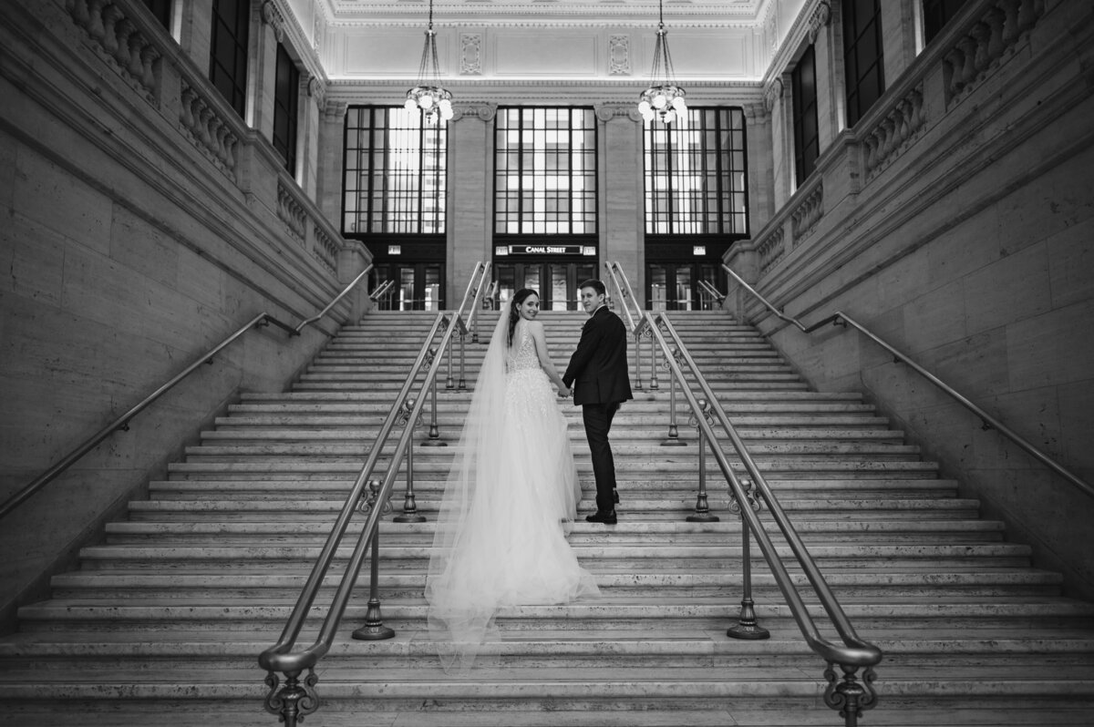 Bride and groom walk up the steps at the Chicago Union Station