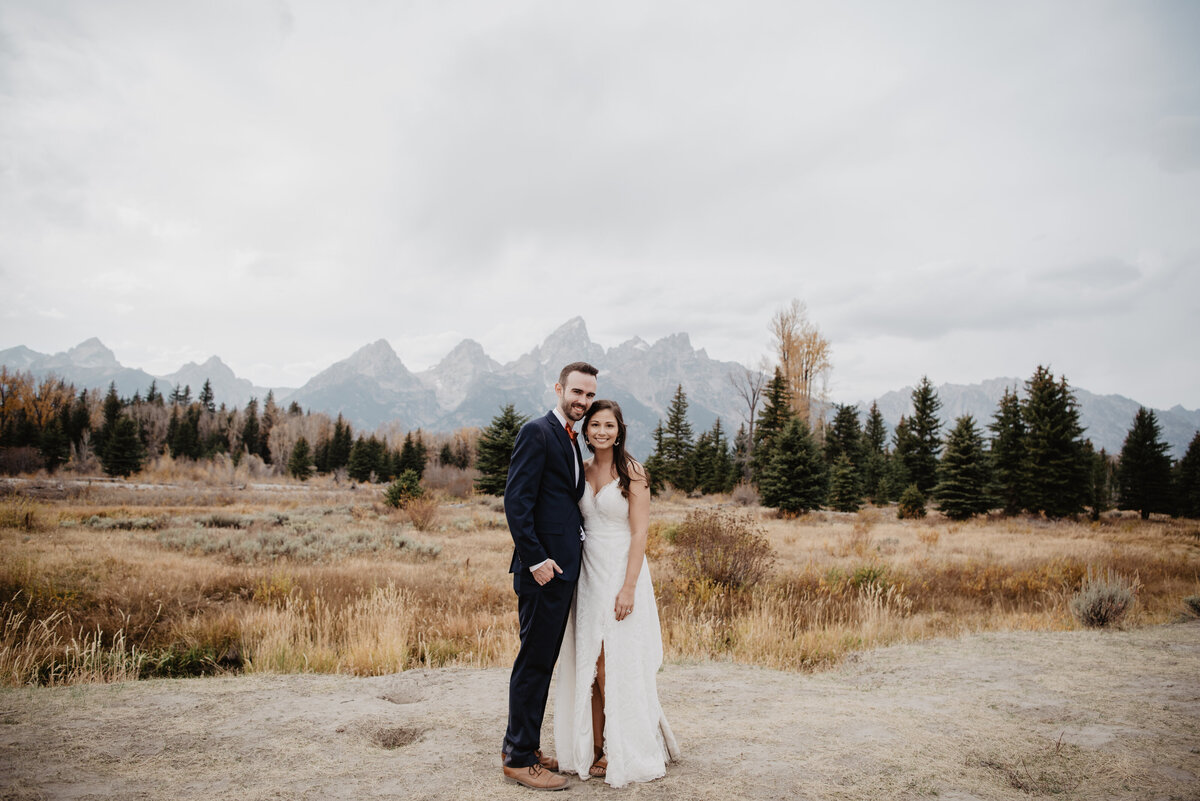 Photographers Jackson Hole capture bride and groom standing in front of Tetons after Grand Teton elopement