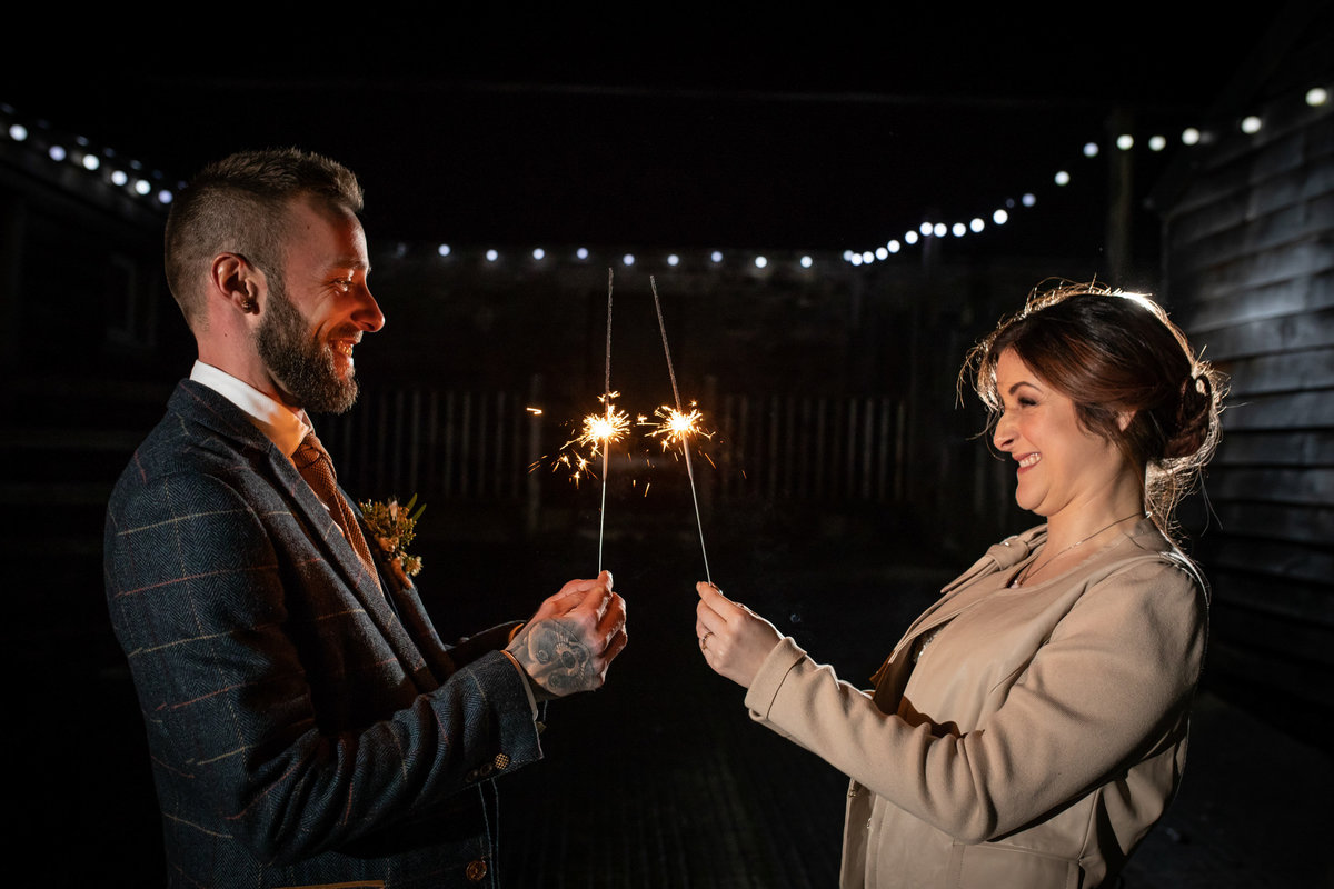 Newly married couple with sparklers at The Green in Cornwall