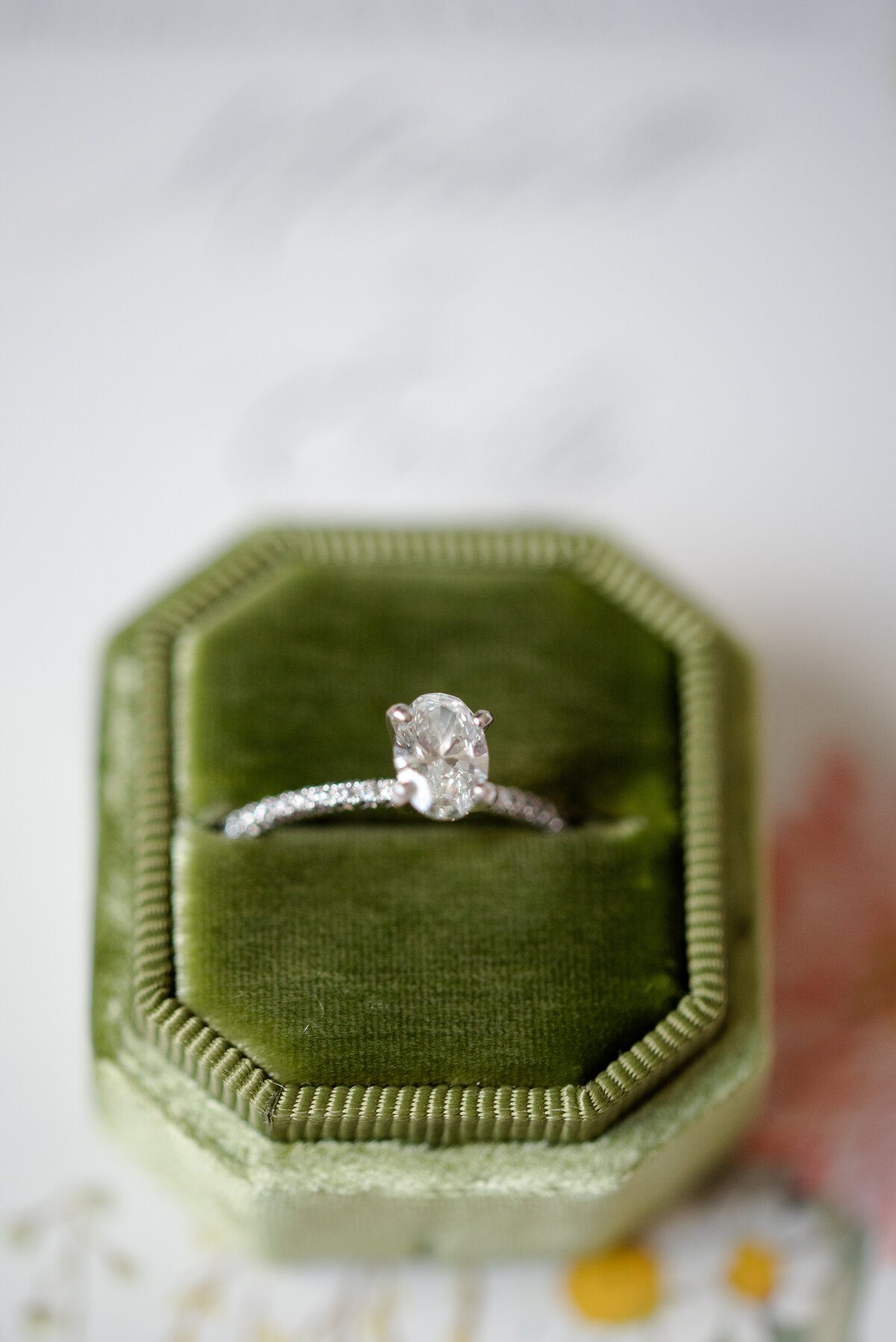diamond ring in a green velvet ring box