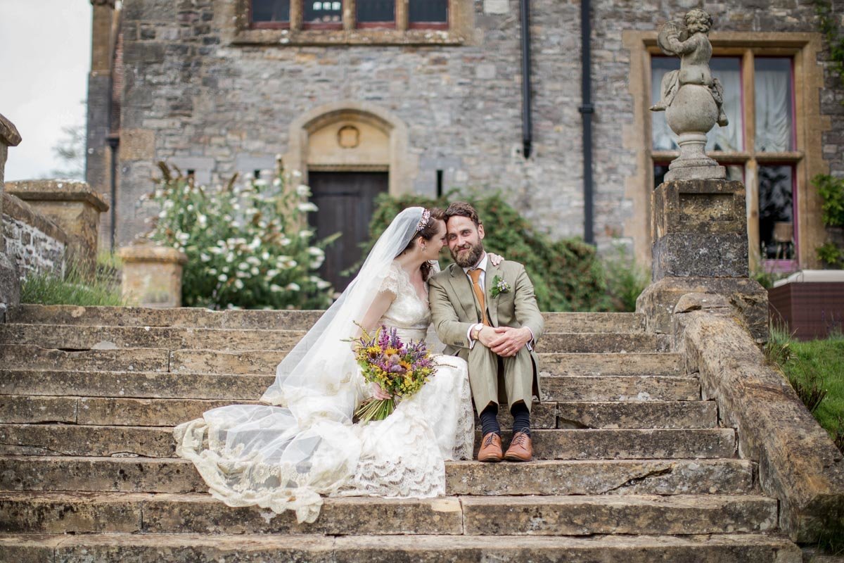 Bride and Groom on steps at Huntsham Court Devon