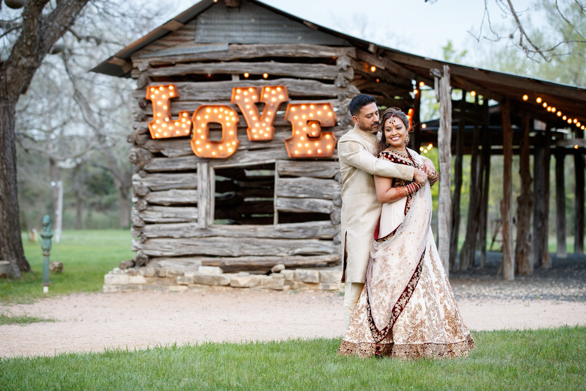 Indian wedding photographer pecan springs ranch bride groom hug love 10601 B Derecho Drive, Austin, TX 78737