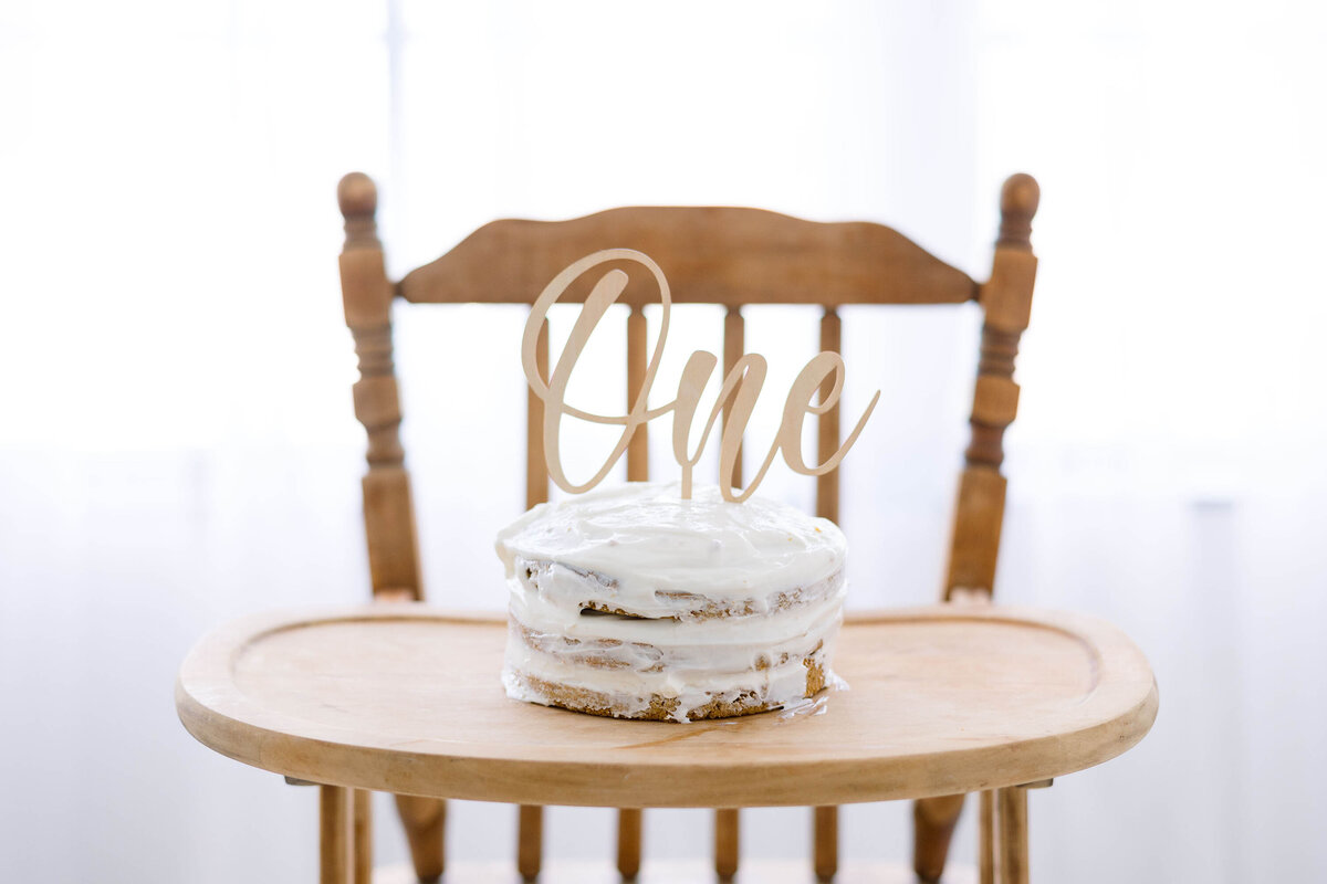 Manchester Portrait Photography session with Kathleen Jablonski includes a white cake on a high chair in a white studio which compliments her light and airy style.