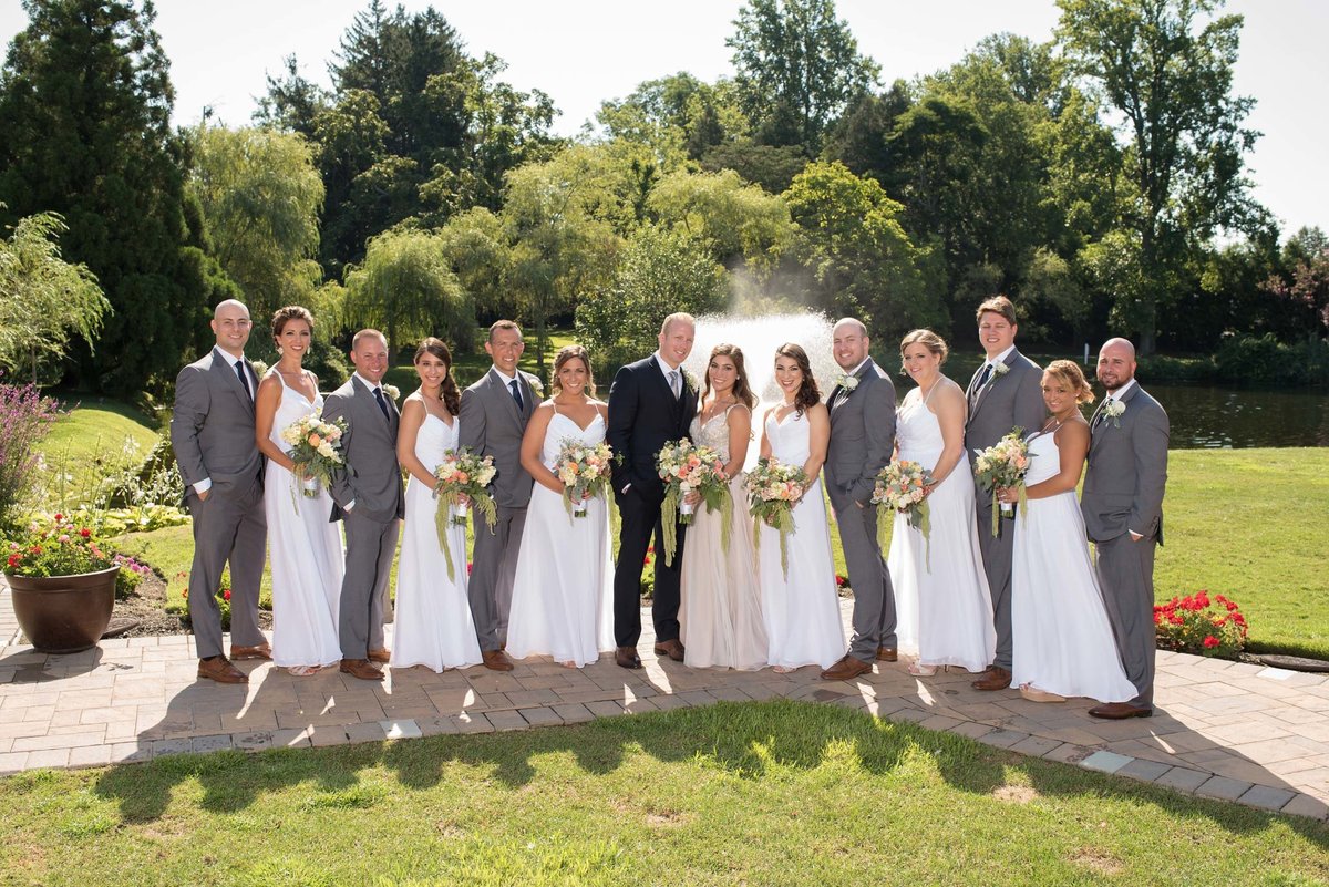 Bridal party posing outside at Flowerfield
