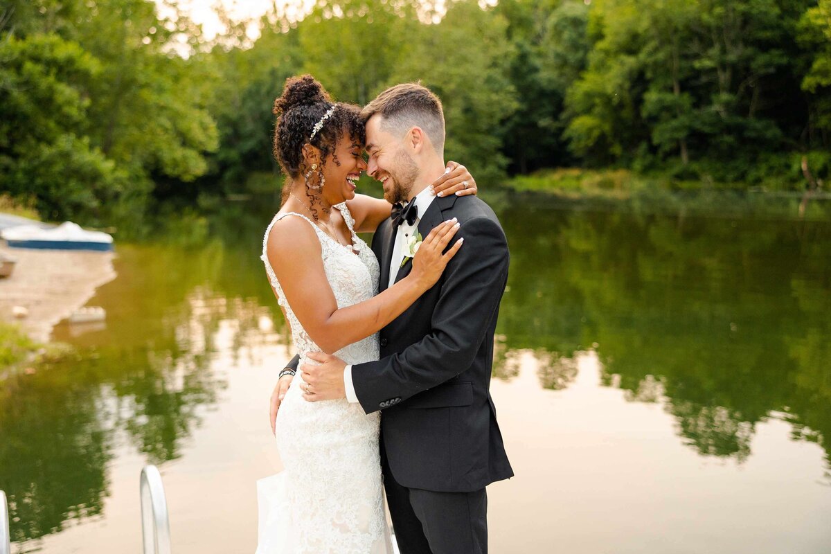 Interracial wedding photo by pond