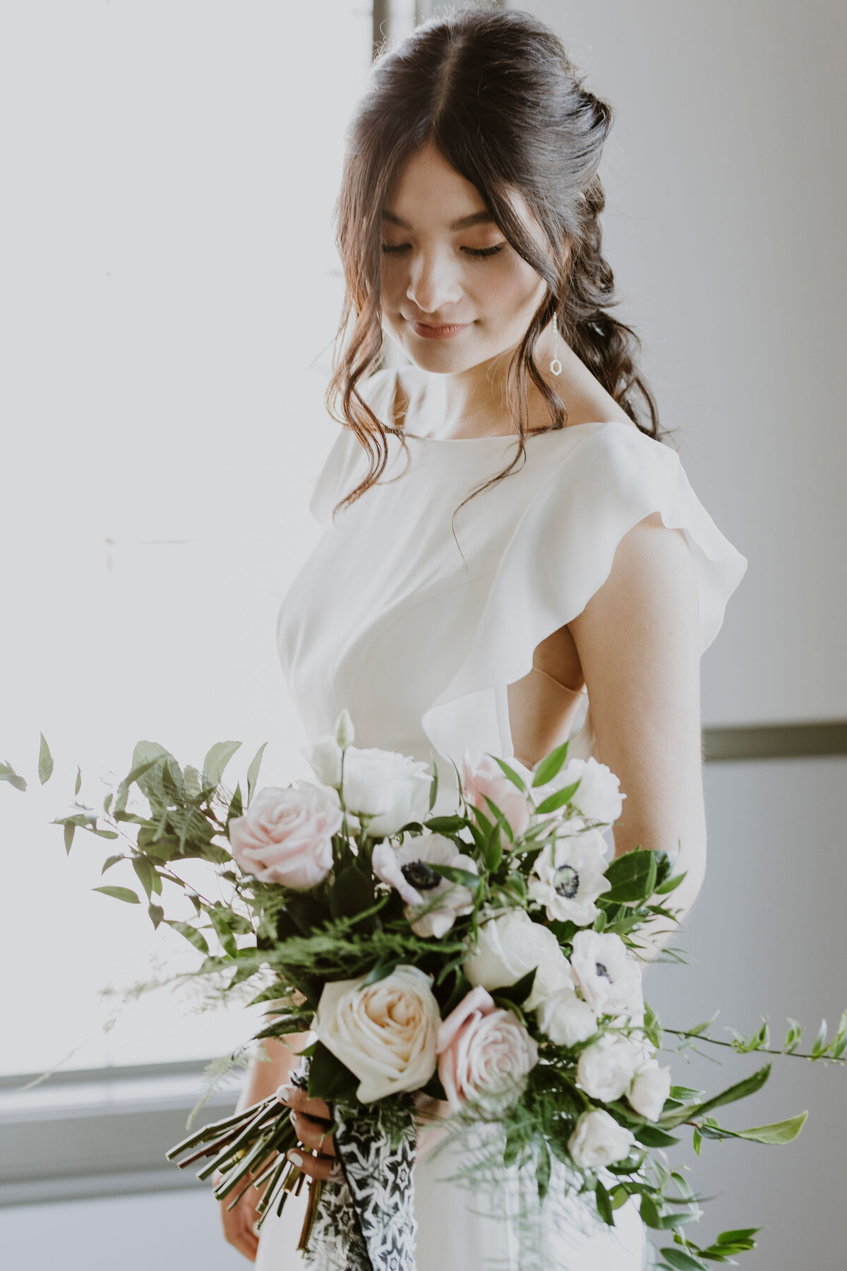 Romantic and elegant bridal bouquet with pink and white roses by Hen & Chicks, classic Calgary, Alberta wedding florist, featured on the Brontë Bride Vendor Guide.