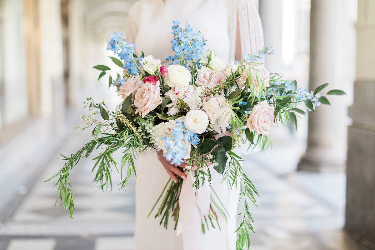 Stunning bouquet of blue, white, pink and red florals captured by Jennifer Chabot Photography, classic and romantic wedding photographer in Calgary,  Alberta. Featured on the Bronte Bride Vendor Guide.