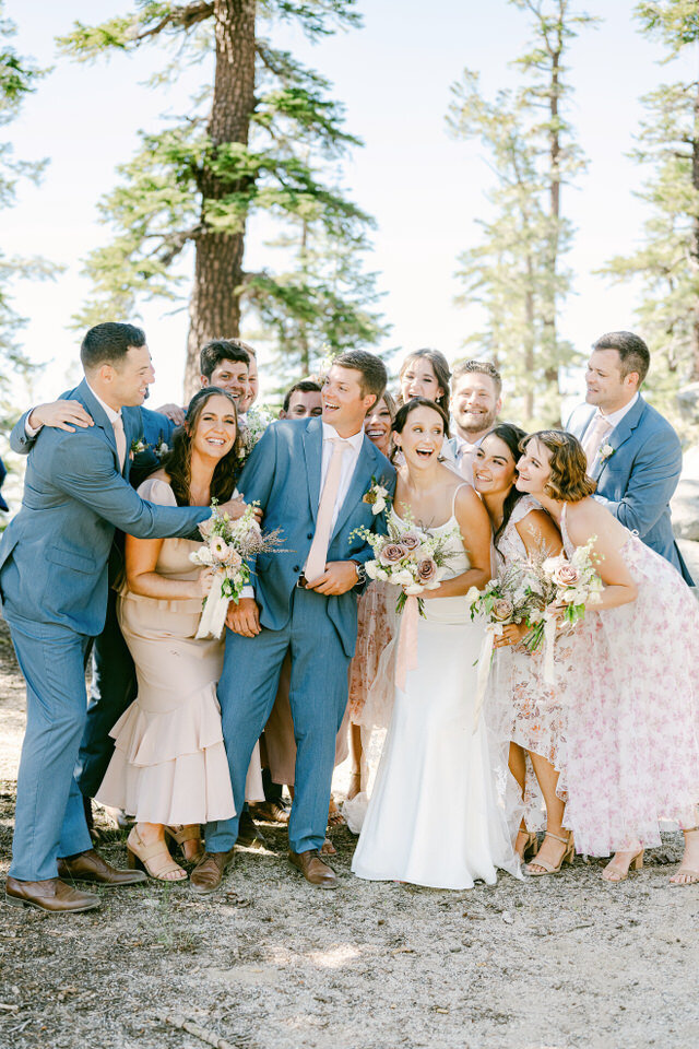 Wedding group laughing in Tahoe forest