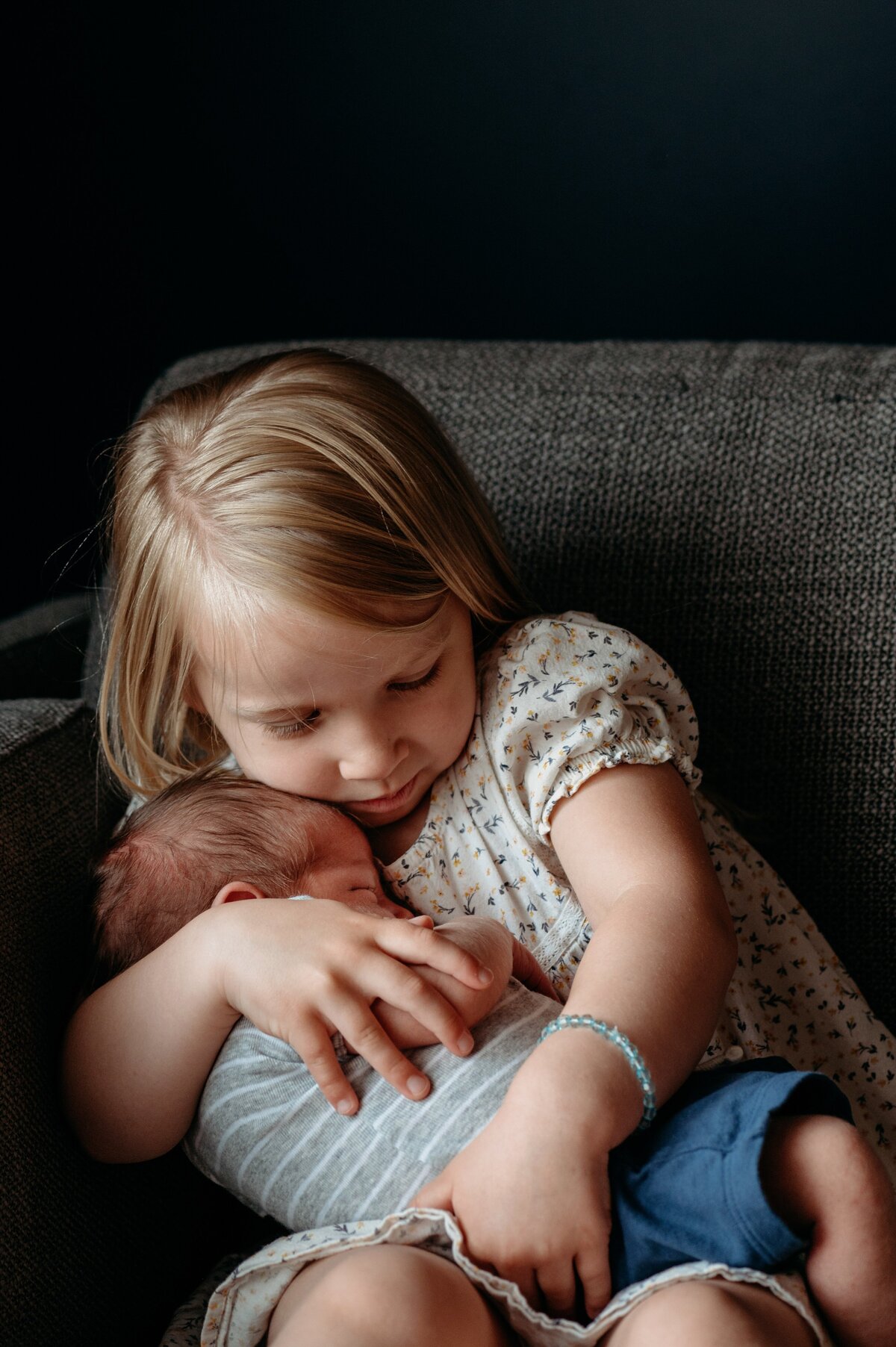 Big sister holding baby