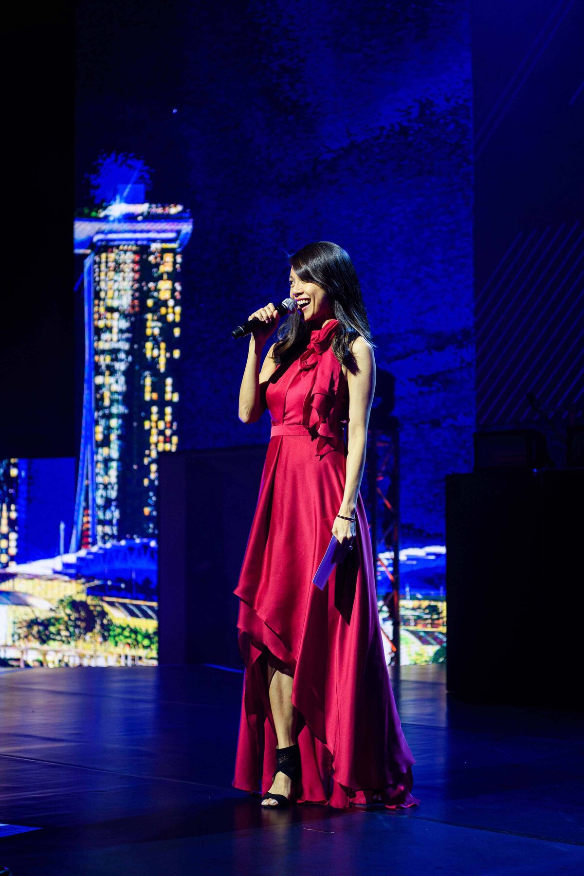 Women performs in formal red dress in Signapore for teradata conference