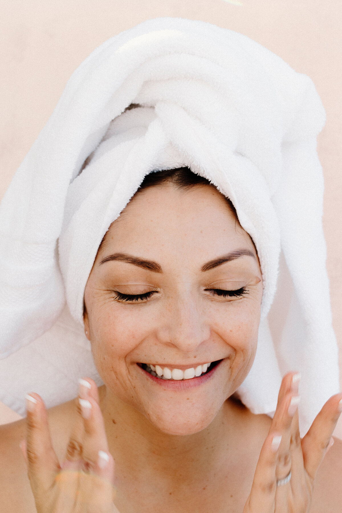 woman applying serum with a white towel