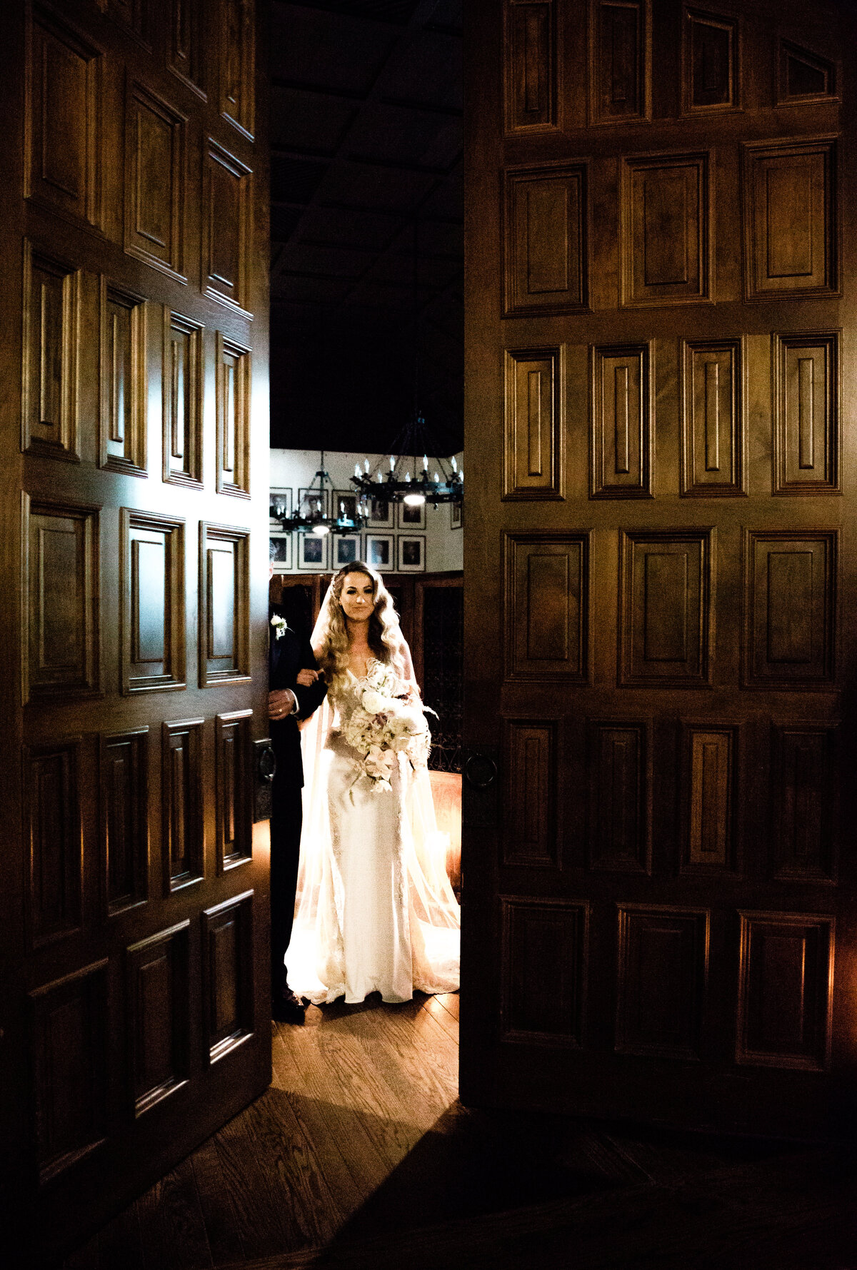 bride looking through wood doors