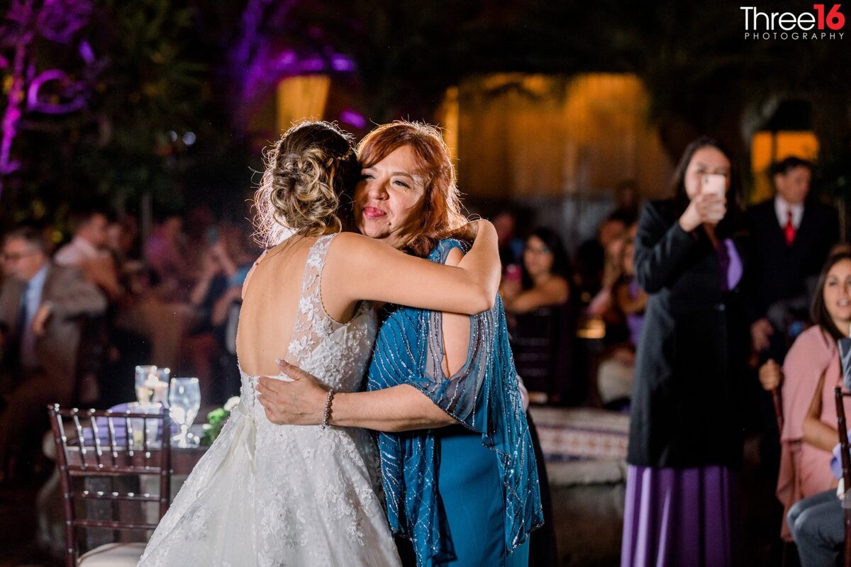 Bride hugs her mom after a toast