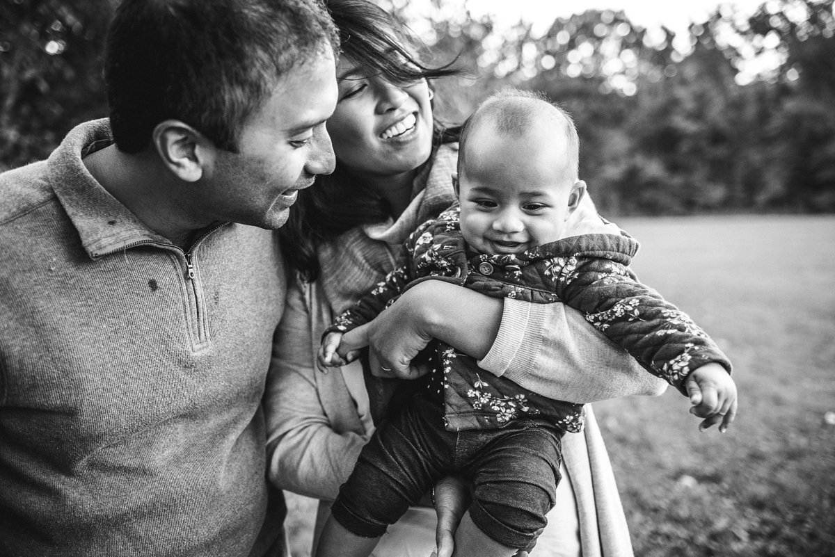 family smile in field black and white