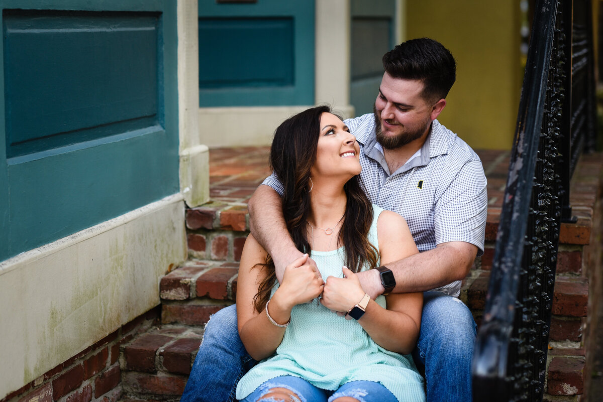 Beautiful Mississippi Engagement Photography: couple relaxes on brick staircase in Ocean Springs, MS