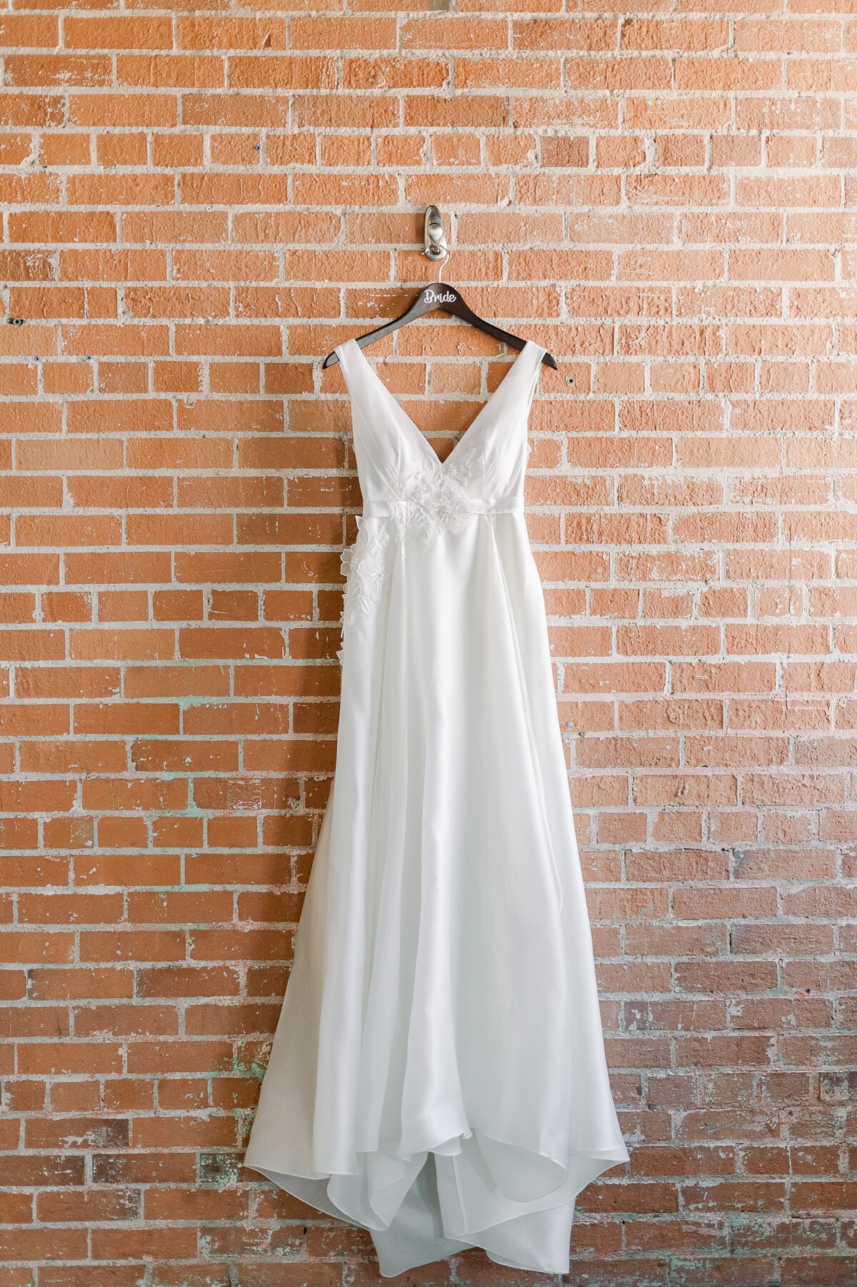 Bride gown on brick wall by phoenix wedding photographer