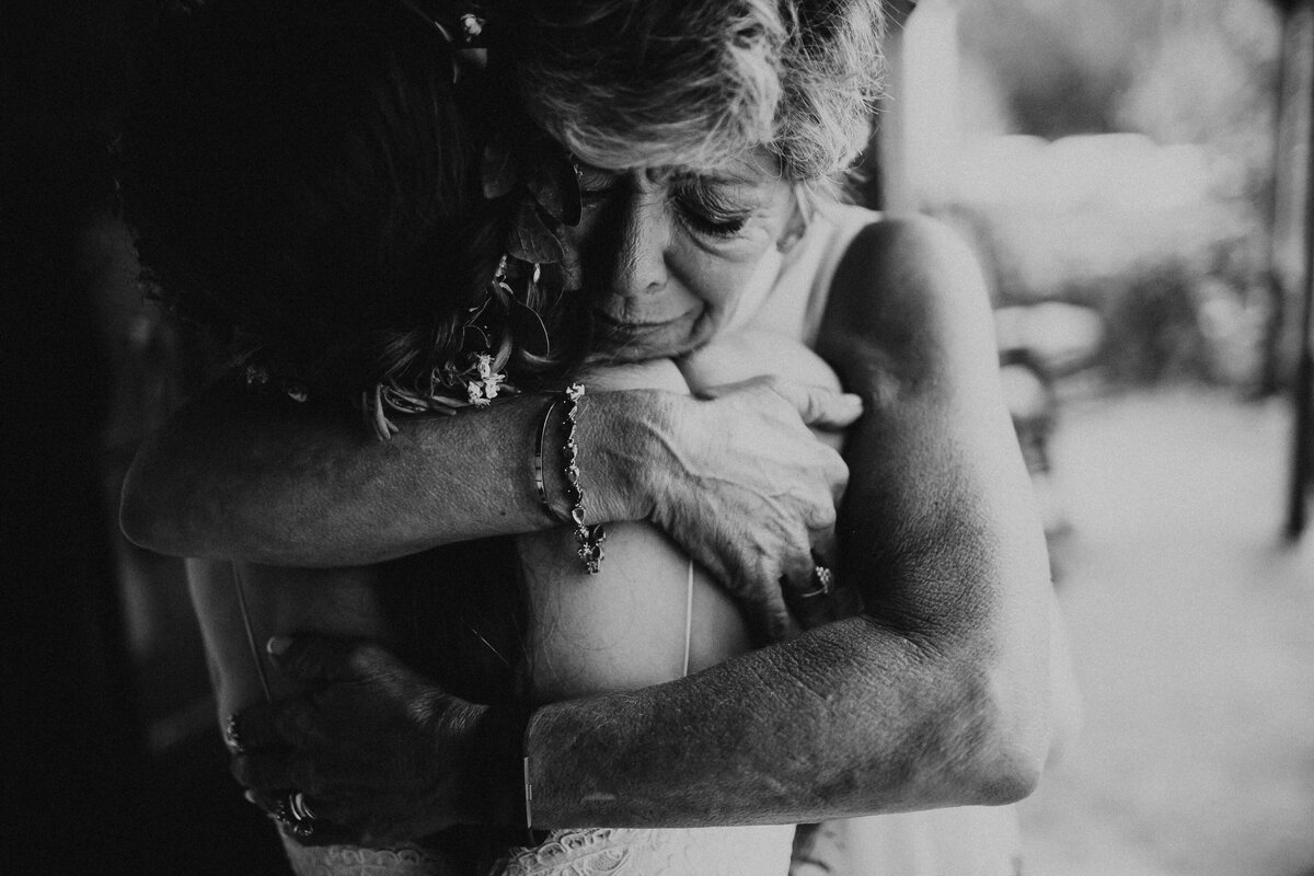 mom crying hugging daughter bride