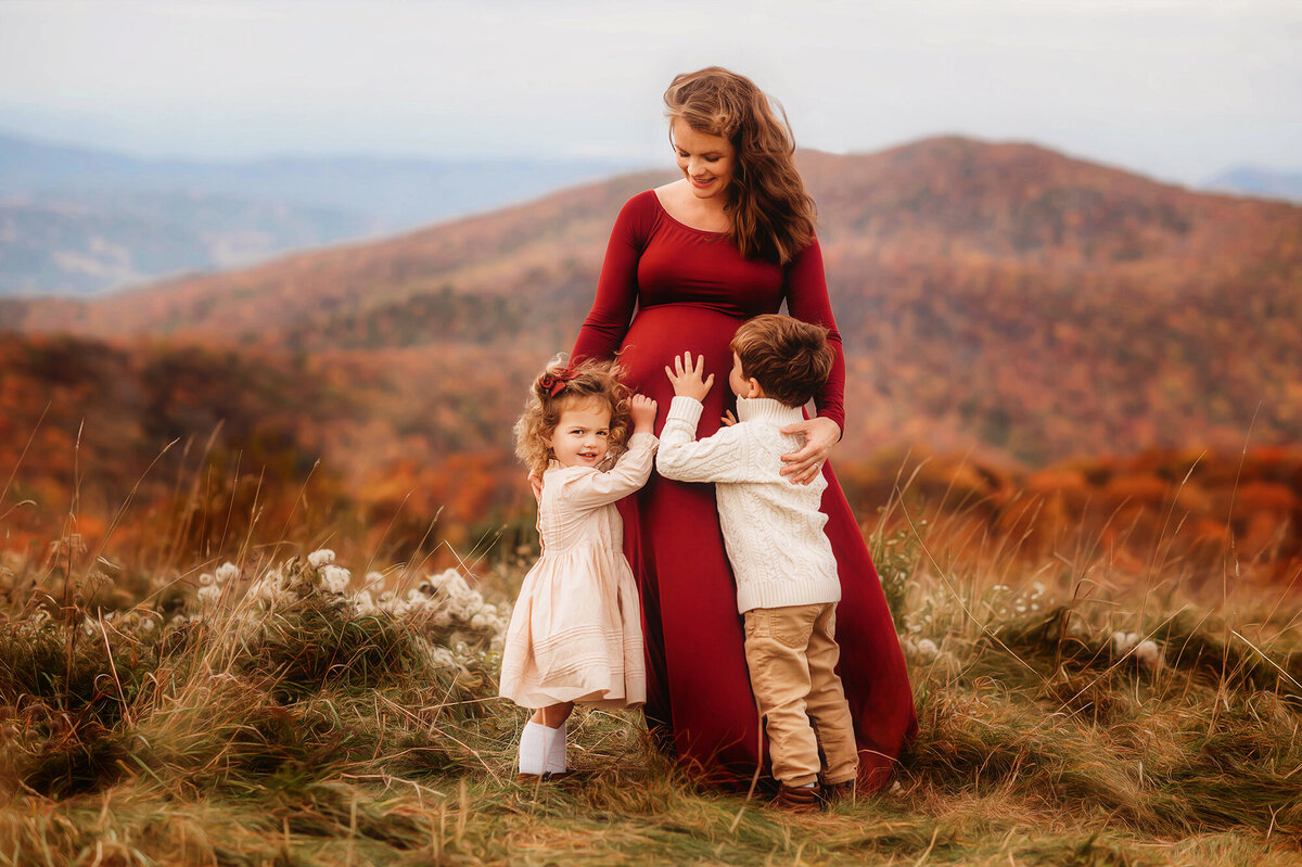 Mother embraces her children during Family Photoshoot at Max Patch in Asheville, NC.