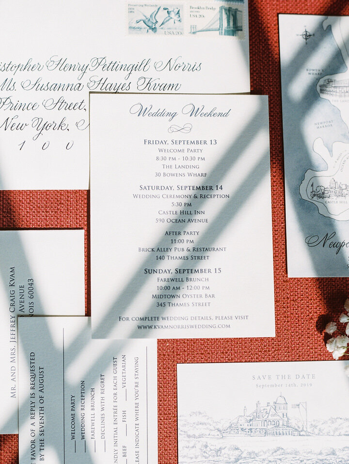 invitation suite on red background for castle hill inn wedding
