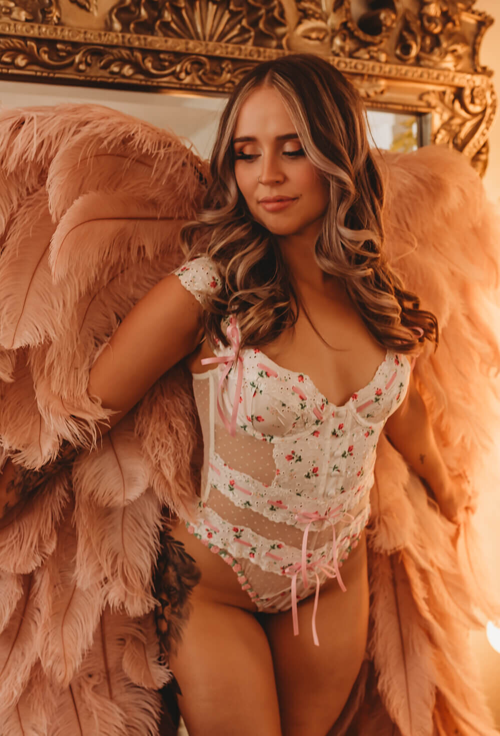 Bride in pink and white lingerie with angel wings near San Fransisco.