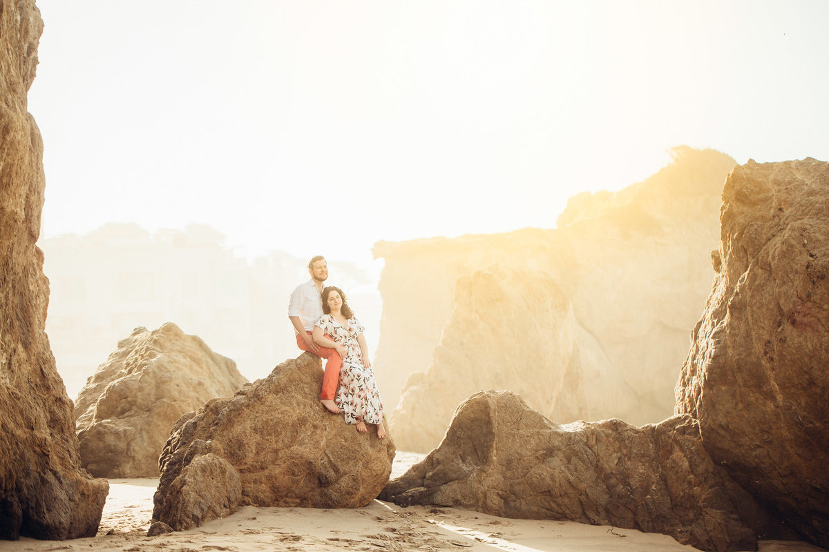 Engagement Photograph Of  Man And Woman Seated On a Rock Formation Los Angeles