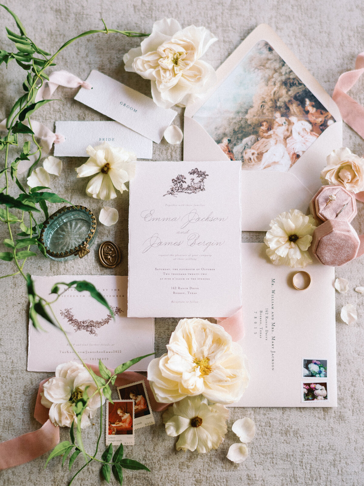 Bespoke bridal stationary with white flowers and calligraphy and vintage stamps on wedding day