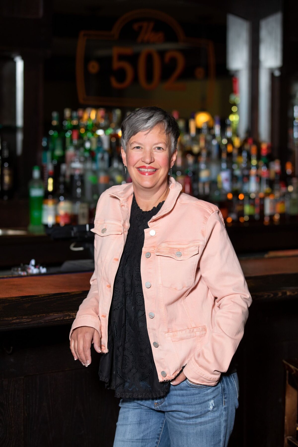On-Location portrait of Manager Beth Wilson standing in front of the bar at Chase on the Lake Walker Minnesota.