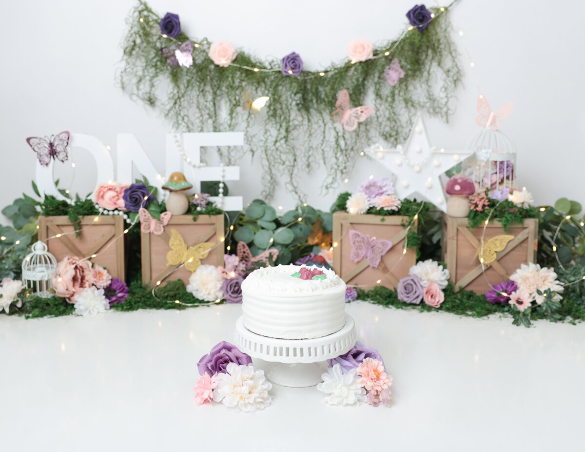 A floral cake smash experience in Rochester, NY.