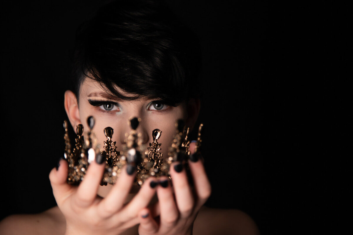 Teen-girl-with-black-hair-holding-crown